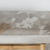 close up view of the cowhide pattern on the mottled grey cowhide ottoman