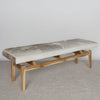 angled view of a mottled grey cowhide bench or ottoman