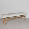 angled view of a creamy coloured cowhide bench seat