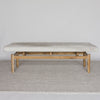 front view of the cream coloured cowhide on top of a ottoman bench by corcovado