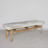 angled view of a cream and grey cowhide ottoman bench seat from corcovado