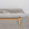 close up view of one end of a cream and grey cowhide ottoman bench seat from corcovado