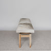 end view of a cowhide bench seat in cream and grey tones from corcovado