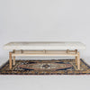 front view of our modern cowhide bench seat ottoman on top of a turkish rug