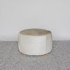 creamy tones on a round cowhide ottoman coffee table by corcovado