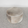 top down view of the top part of the grey and cream round cowhide ottoman coffee table