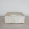 square cowhide ottoman coffee table with small teak wood feet