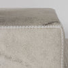 close up photo of a cream light coloured sqarae cowhide ottoman coffee table