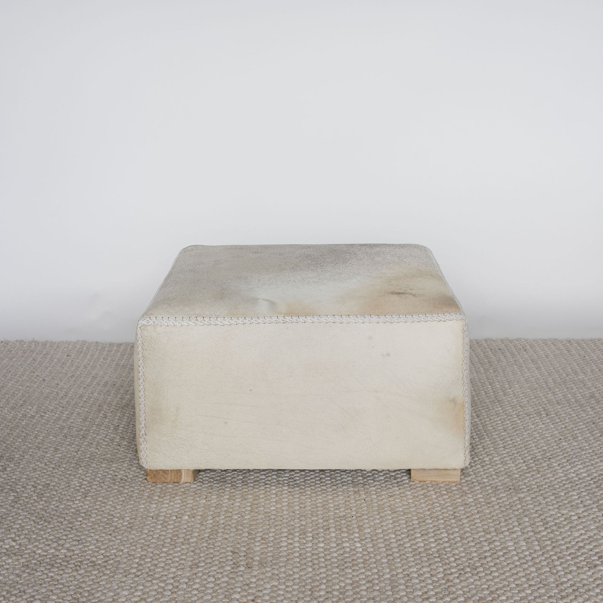 cream light coloured sqarae cowhide ottoman coffee table 