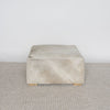 square cowhide ottoman coffee table in natural tones