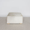 front view of the square cowhide ottoman coffee table in natural tones