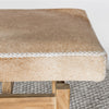 close up of the stitching on a caramel earthy coloured cowhide bench seat