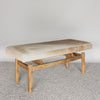 angled view of a caramel earthy coloured cowhide bench seat