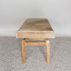 end view of a caramel earthy coloured cowhide bench seat