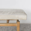 close up end view of a light coloured cream cowhide bench seat from corcovado