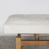 close up end view of a light coloured cream cowhide bench seat from corcovado