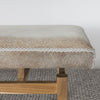 close up photo of the end of an earthy cream colored cowhide bench seat from corcovado