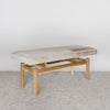 angled view of an earthy cream colored cowhide bench seat from corcovado