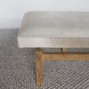 close up end view of the cowhide bench seat in light cream tones by corcovado