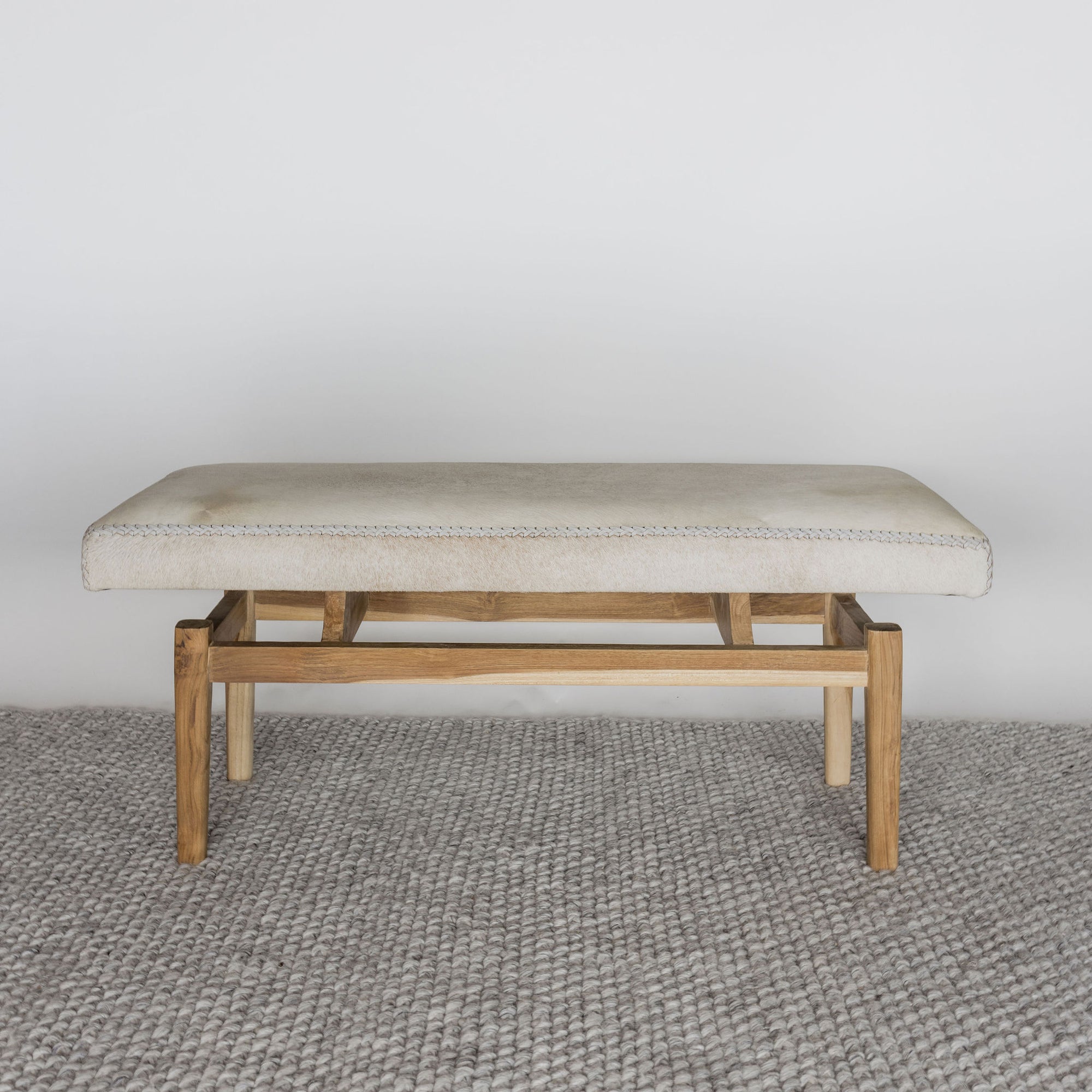 cowhide bench seat in light cream tones by corcovado