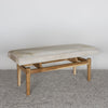 angled view of the cowhide bench seat in light cream tones by corcovado