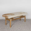 angled view of the caramel coloured and cream cowhide bench seat