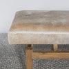 close up view of the end of a Corcovado cream and brown coloured cowhide bench seat for entrances and ends of beds.