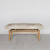 cream and brown coloured cowhide bench seat for entrances and ends of beds.