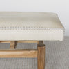 close up end view of the cream coloured cowhide ottoman bench seat