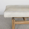 close up showing the leather stitching on the cream coloured cowhide ottoman bench seat from corcovado