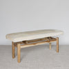 angled view of the cream coloured cowhide ottoman bench seat