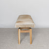 end view of a caramel brown and cream coloured cowhide bench seat by corcovado