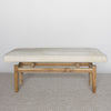 front view of a cream cowhide bench seat ottoman