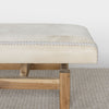 another close up photo of  light cream coloured cowhide bench seat