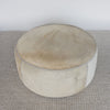 photo of the top of the large round cowhide ottoman coffee table