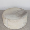 top down view of a cream and grey cowhide round ottoman from corcovado