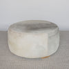 front view of the cream and grey cowhide round ottoman from corcovado