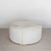 another view of the cream coloured light cowhide round ottoman coffee table