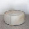 round cowhide ottoman coffee table with leather stitching details