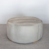 neutral coloured round cowhide ottoman coffee table