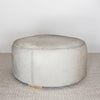 round neutral toned natural cowhide ottoman coffee table