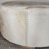 close up detail of the leather stitching on the neutral toned natural cowhide ottoman coffee table