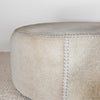 close up of the round  natural cowhide ottoman coffee table