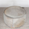 top down view of the round neutral toned natural cowhide ottoman coffee table