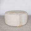 cream coloured round cowhide ottoman from corcovado