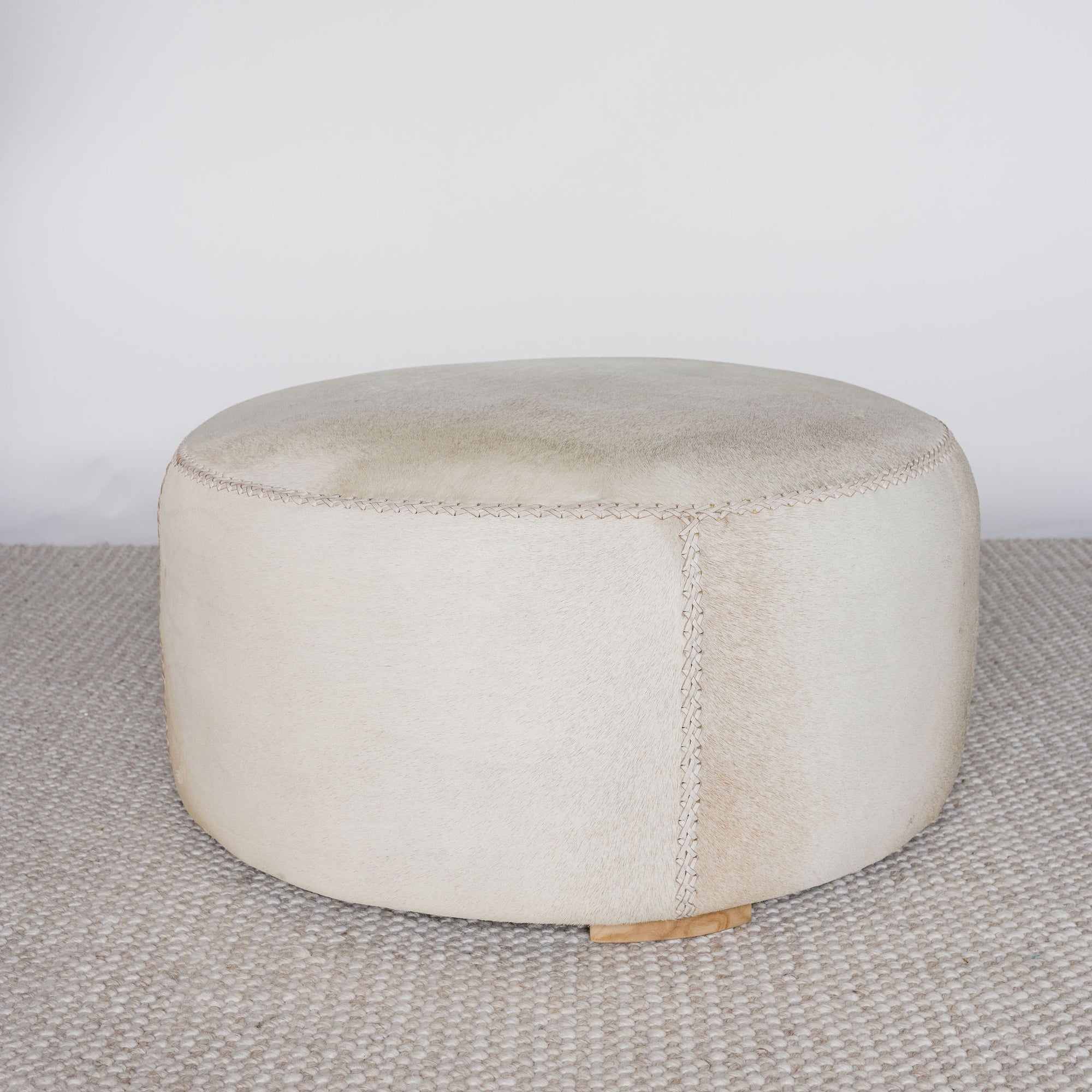 cream coloured round cowhide ottoman from corcovado 