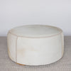 cream coloured round cowhide ottoman coffee table from corcovado