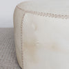 close up of the stitching on cream coloured round cowhide ottoman coffee table from corcovado