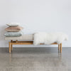 cream boucle bench seat from corcovado for entrance way and bedroom benches with a white icelandic sheepskin on top