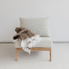 copper colored wool blend throw over an oversized armless chair by Corcovado